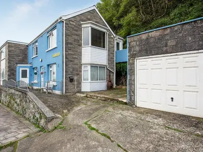 a blue and white house with a white garage at Brig-Y-Don in Aberaeron