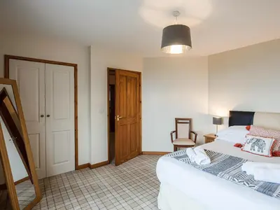 a bedroom with a bed and a wooden door at Brig-Y-Don in Aberaeron