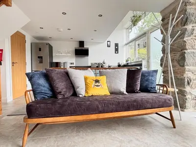 a living room with a brown couch with blue pillows at 1 Bed in Dolgellau oc-bow292 in Dolgellau