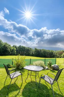 two chairs and a table in the grass with a sun at 1 Bed in Dolgellau oc-bow292 in Dolgellau