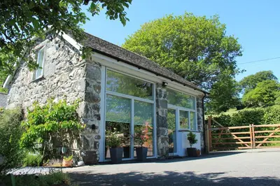 a stone cottage with large windows at 1 Bed in Dolgellau oc-bow292 in Dolgellau
