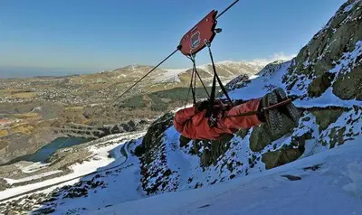 a red object is hanging from a mountain at 3 Bed in Tywyn oc-bow248 in Abergynolwyn