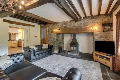 a living room with a couch and a fireplace at 3 Bed in Tywyn oc-bow248 in Abergynolwyn