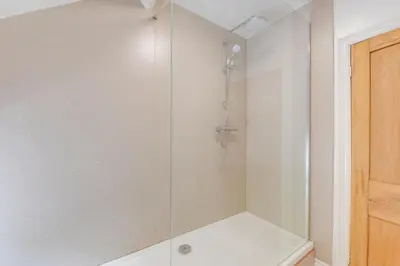 a shower with a glass door in a bathroom at 3 Bed in Tywyn oc-bow248 in Abergynolwyn