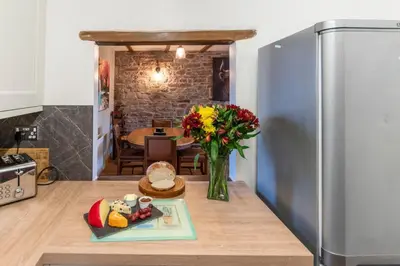 a kitchen with a refrigerator and a vase of flowers at 2 Bed in Cray oc-bow287 in Cray