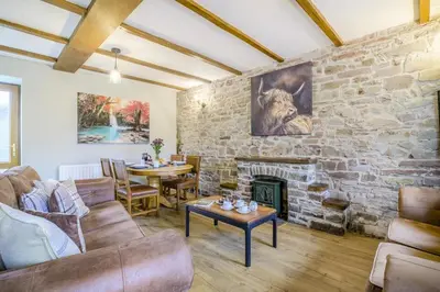 a living room with a stone wall with a fireplace at 2 Bed in Cray oc-bow287 in Cray