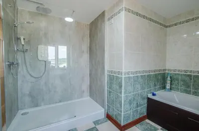 a bathroom with a shower and a tub and a sink at 4 Bed in Cray oc-bow288 in Cray