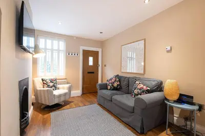 a living room with a couch and a tv at Besford Square, Shrewsbury Town in Shrewsbury