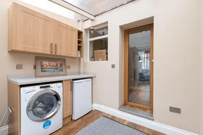 a laundry room with a washer and dryer at Besford Square, Shrewsbury Town in Shrewsbury
