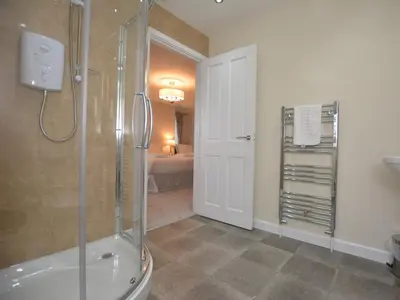 a bathroom with a shower and a walk in shower at Pengarreg Fawr in Aberystwyth