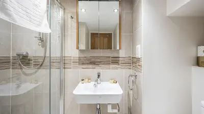 a white bathroom with a sink and a shower at Romantic Couples' Getaway - at Ty Cerrig Barn with luxury hot tub in Corwen