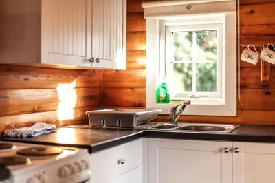 a kitchen with a stove and a sink and a window at 3 Bedroom Log Cabin in Snowdonia nr MTB trails in Tanygrisiau