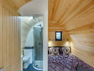 a bedroom with a shower and a bed in a room at Elm-Uk36259 in Llanfair Caereinion
