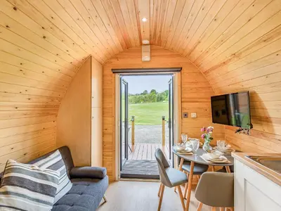a room with a couch and a table in a tiny house at Oak-Uk36258 in Llanfair Caereinion