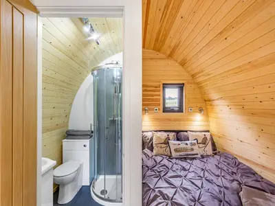 a small bathroom with a bed and a shower at Oak-Uk36258 in Llanfair Caereinion