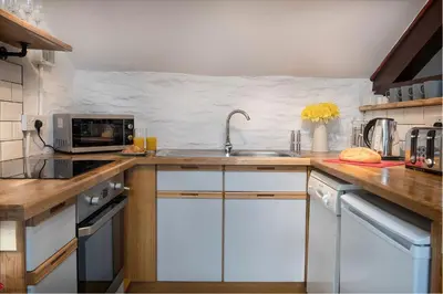 a kitchen with a sink and a microwave at Granary Retreat for 2 inc shared Dog Field in Bryn-crug