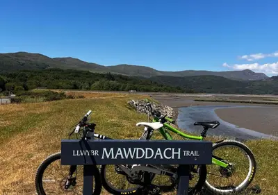 a bike parked on the side of a road at Cowshed Cottage with Log Burner & Shared Dog Field in Bryn-crug