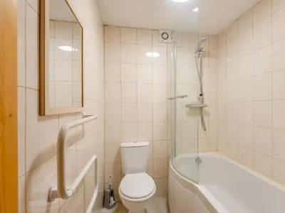 a bathroom with a toilet and a tub and a sink at Robins Nest - Uk36208 in Llanfihangel-y-creuddyn