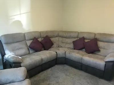 a couch with pillows on it in a living room at Haul y Bore in Aberystwyth