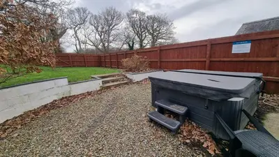 a grill in a yard next to a fence at Cottage #1 in Aberystwyth