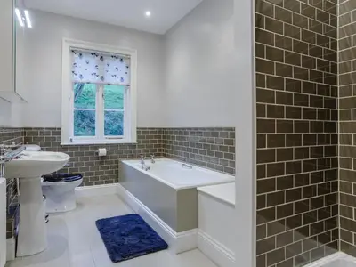 a bathroom with a tub and a sink at Old Upper Gwestydd in Highgate