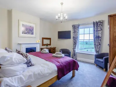 a bedroom with a bed and a window at Old Upper Gwestydd in Highgate
