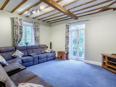 a living room with a couch and a table at Old Upper Gwestydd in Highgate