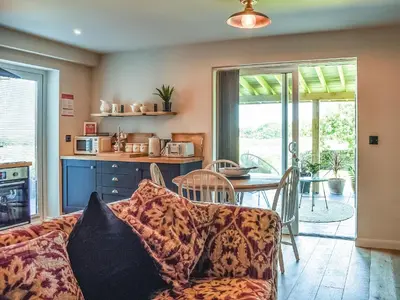 a living room with a couch and a table at Afonig Loyw in Dyffryn