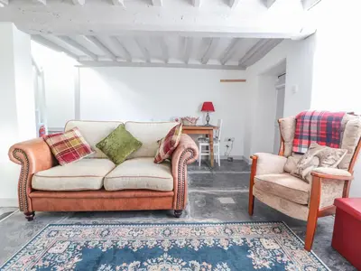 a living room with two chairs and a couch at 1 Hendom in Corwen