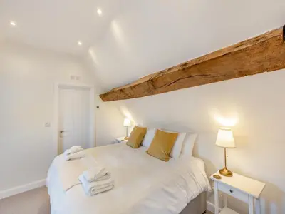 a bedroom with a white bed with towels on it at Buckley Farm, Barn 2 - Uk36586 in Oswestry