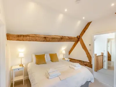 a bedroom with a large white bed with two pillows at Buckley Farm, Barn 2 - Uk36586 in Oswestry