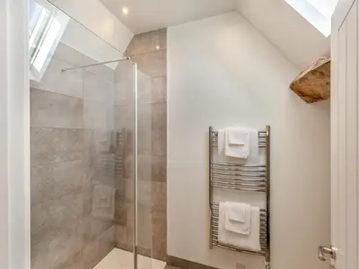 a bathroom with a shower with a glass door at Buckley Farm, Barn 2 - Uk36586 in Oswestry
