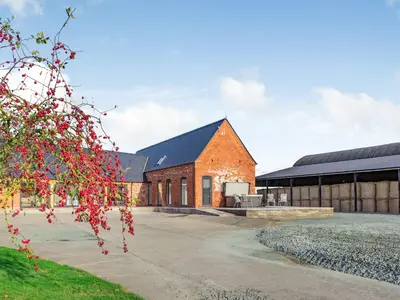 a red brick building with a black roof at Buckley Farm, Barn 2 - Uk36586 in Oswestry