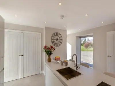 a kitchen with a sink and a clock on the wall at Buckley Farm, Barn 2 - Uk36586 in Oswestry