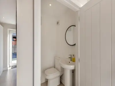 a white bathroom with a toilet and a sink at Buckley Farm, Barn 2 - Uk36586 in Oswestry