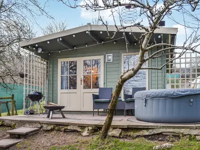 a green house with a porch and a grill at Ty Bach Twt - Uk36419 in Talybont