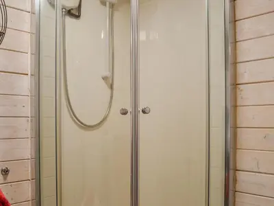 a shower with a glass door in a bathroom at Ty Bach Twt - Uk36419 in Talybont