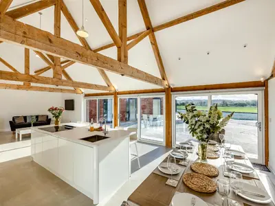 a kitchen with a white island in a room with windows at Buckley Farm, Barn 1 - Uk36588 in Oswestry