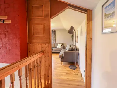 a hallway with a door leading to a living room at Pengeulan in Machynlleth