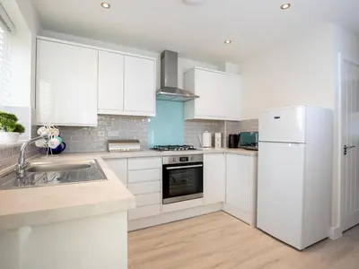 a kitchen with white cabinets and a white refrigerator at 2 Bedroom Home Near the Heart of Ludlow - Pass the Keys in Ludlow