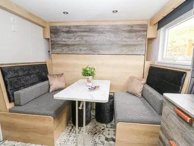 a small table and chairs in a tiny house at Hares Rest in Rhayader
