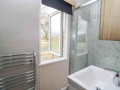 a bathroom with a sink and a window at Hares Rest in Rhayader