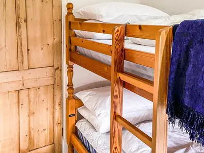 a couple of bunk beds in a room at New Cottage in Penmaenpool