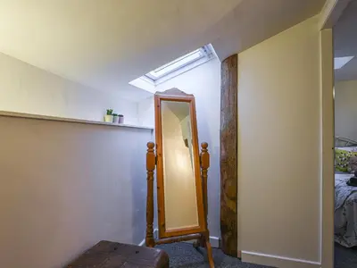 a room with a mirror and a skylight at Bodeinion in Llanfair Caereinion