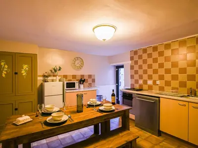 a kitchen with a table with plates on it at Glasfor in Llwyngwril