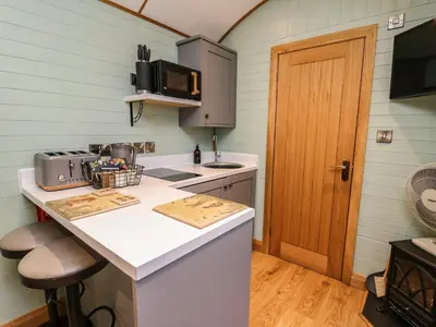 a small kitchen with a counter and a microwave at Highland View in Rhayader