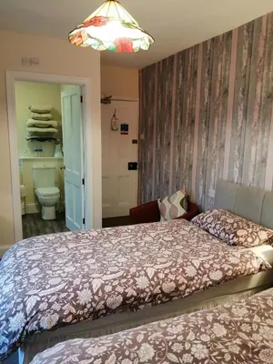 a bedroom with a bed and a bathroom at Lion Hotel in Llanbister