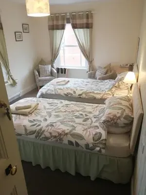 a bedroom with two beds and a window at Lion Hotel in Llanbister