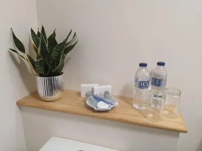 a wooden shelf with bottles of water and a potted plant at Lion Hotel in Llanbister