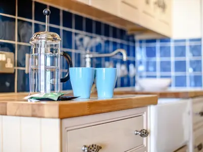 a kitchen counter with two blue cups and a juicer at Apartment 1 - Uk32244 in Aberdyfi